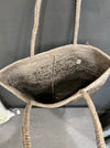 Inside view of the Sophie Digard moss raffia basket bag with crocheted lining and label