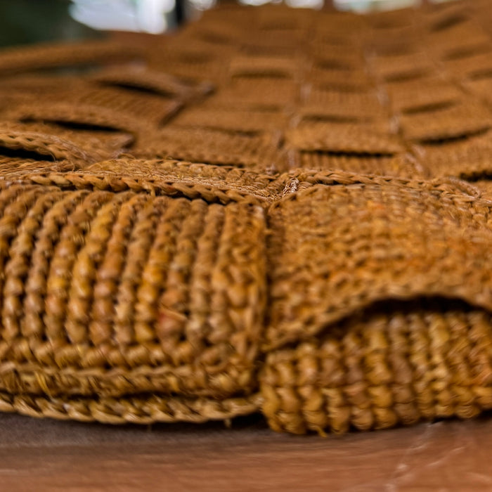 Close-up of the basket-weave pattern on the Sophie Digard mustard raffia tote