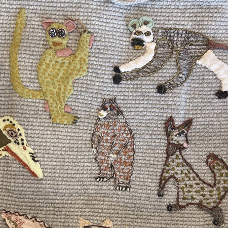 Close-up of embroidered monkey, bear and wildcat appliques on the Sophie Digard wool tote
