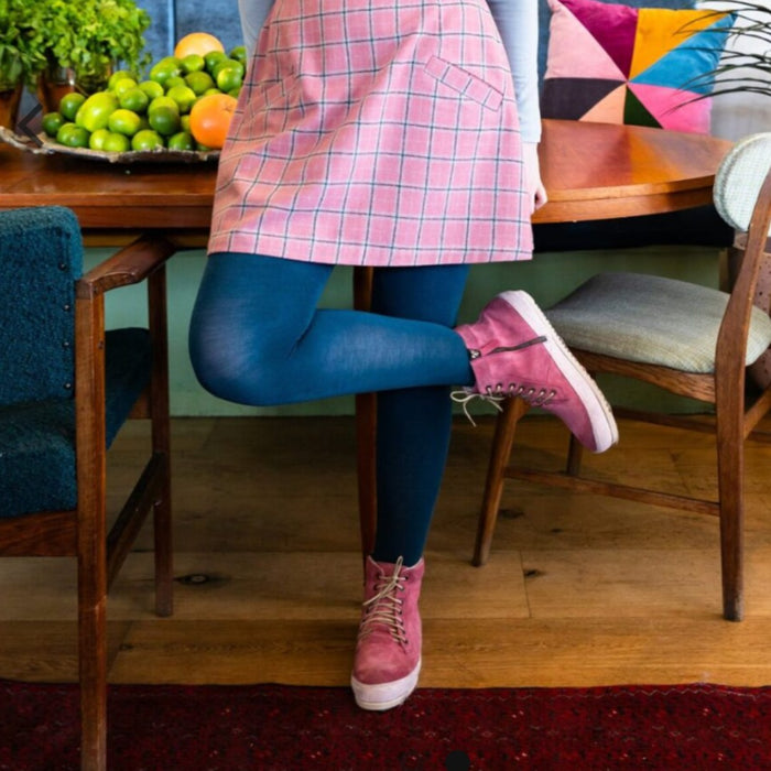Tightology luxe wool tights in blue, worn with pink lace-up boots
