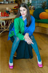 Model wearing Tightology Pine blue patterned cotton tights with green shirt and pink heels
