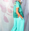 Traces of Me Still silk trousers in aqua, worn with a green top and scarf
