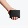 Bellroy Hide & Seek leather wallet in black, held in hand to show its size