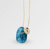Dinosaur Designs Joie de vivre necklace, close-up of blue mineral resin pendant and gold bead