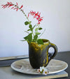 Dinosaur Designs large Rock jug in olive and yellow resin, styled with red flowers
