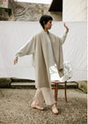 Francie Cloud possum merino scarf in cream, worn as a long wrap outdoors