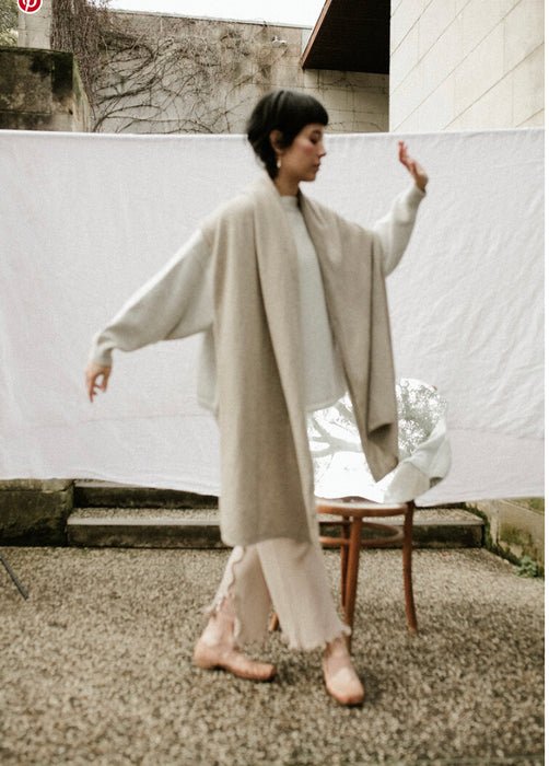 Francie Cloud possum merino scarf in cream, worn as a long wrap outdoors