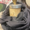 Sophie Digard charcoal grey wool stole wrapped around a candle on display