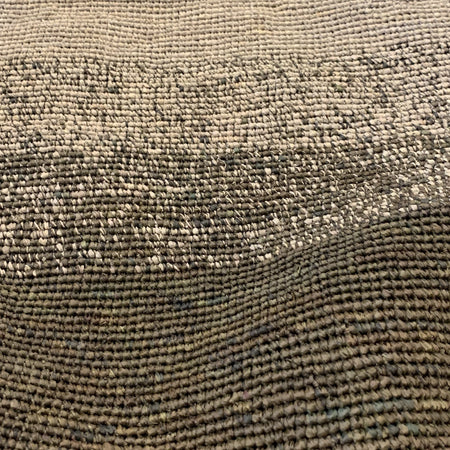 Close-up of the grey ombre crocheted raffia weave on the Sophie Digard moss basket bag